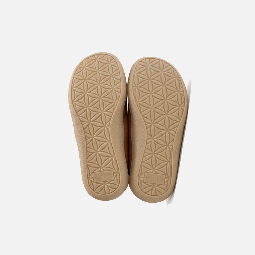 Beige shoe soles with geometric pattern on a white background