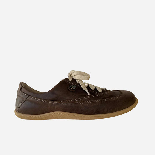 Brown leather shoe with beige laces on a white background