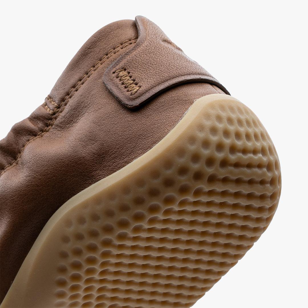 Close-up of tan Vivobarefoot Primus Asana women's barefoot shoe with textured sole