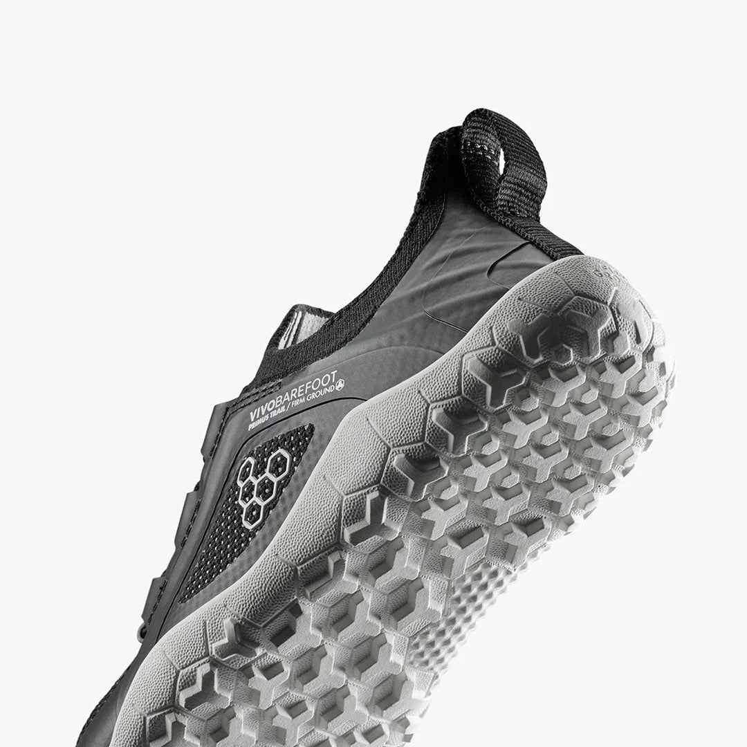 Close-up of black Vivobarefoot minimalist trail running shoe with detailed textured sole
