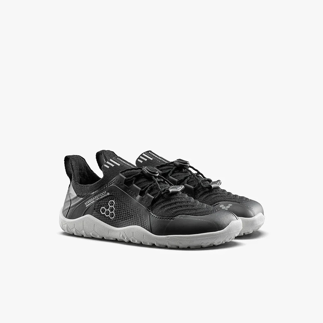 Black and gray Vivobarefoot minimalist running shoes with durable soles and adjustable laces
