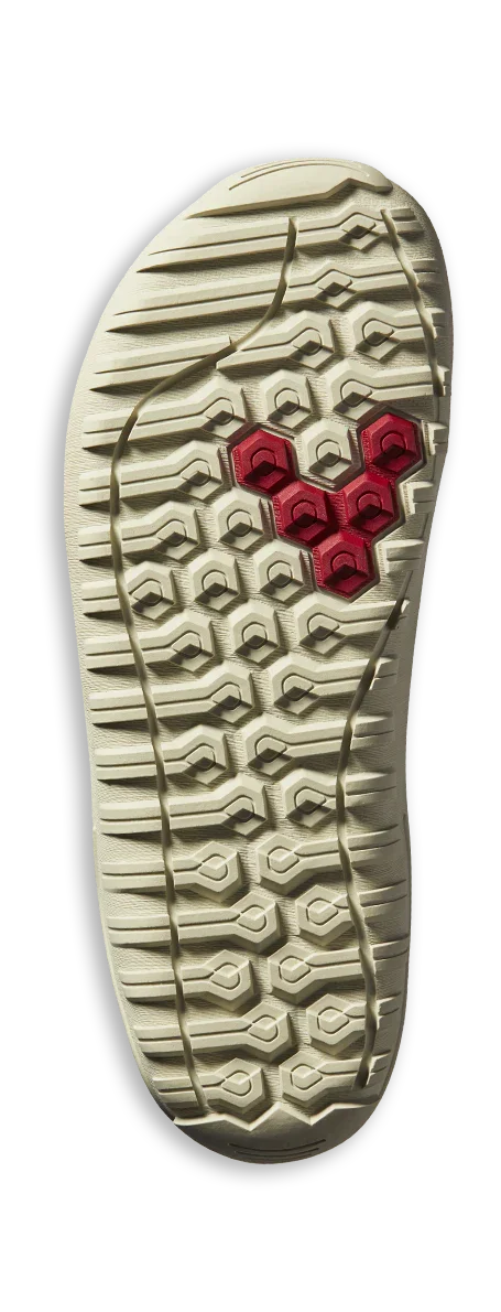 Beige rubber shoe outsole with red hexagonal traction pattern and geometric tread design