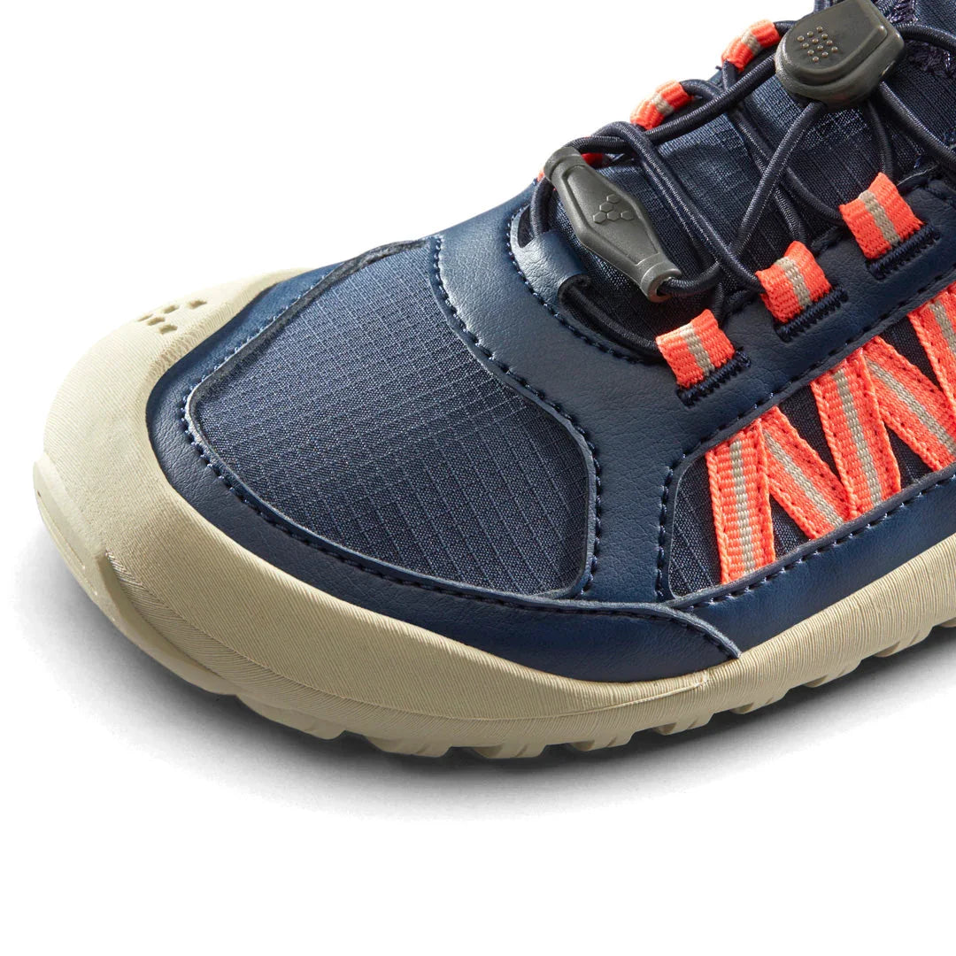 Close-up of navy blue and beige outdoor sneaker with orange laces and protective toe cap