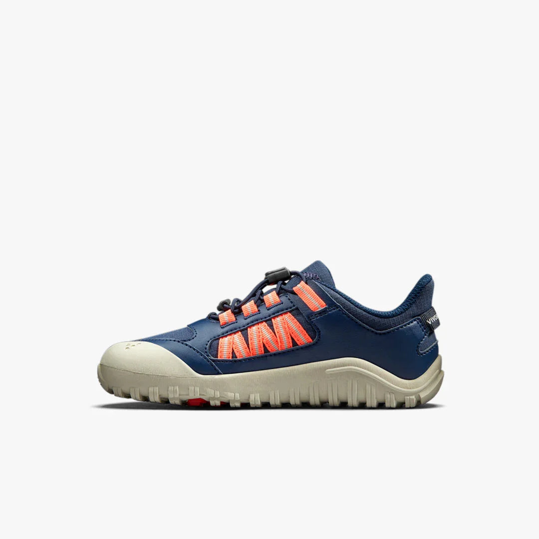 Side view of navy and beige casual sneaker with orange accents and rugged sole on white background