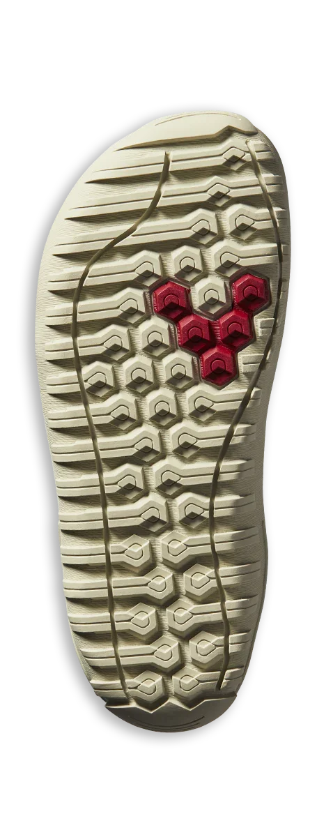 Beige shoe outsole with geometric tread pattern featuring red hexagonal grips