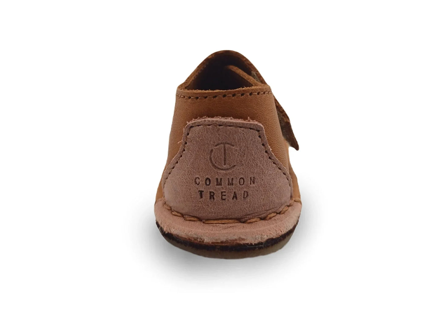 Rear view of brown leather Common Tread shoe with stitched sole on white background