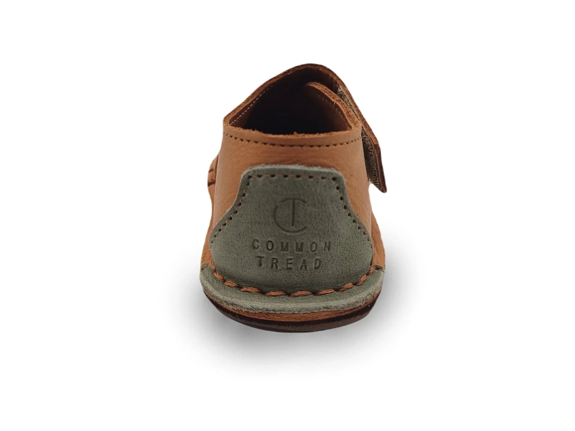 Rear view of tan and gray leather Common Tread slip-on shoe with stitched sole