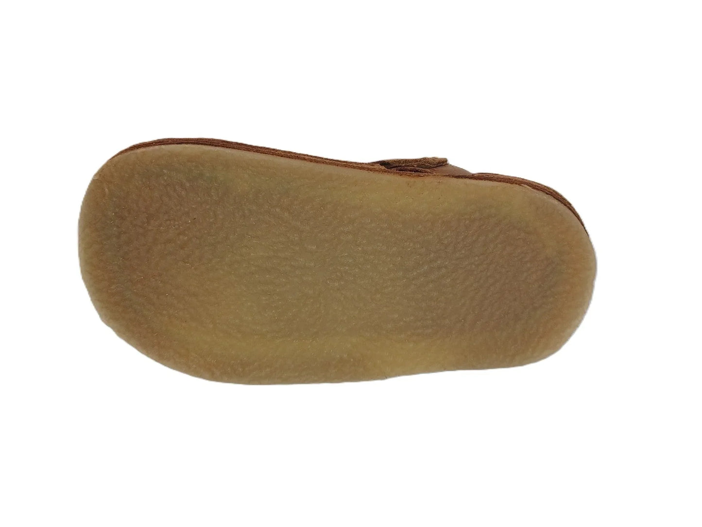 Brown suede shoe with crepe sole viewed from the bottom on white background