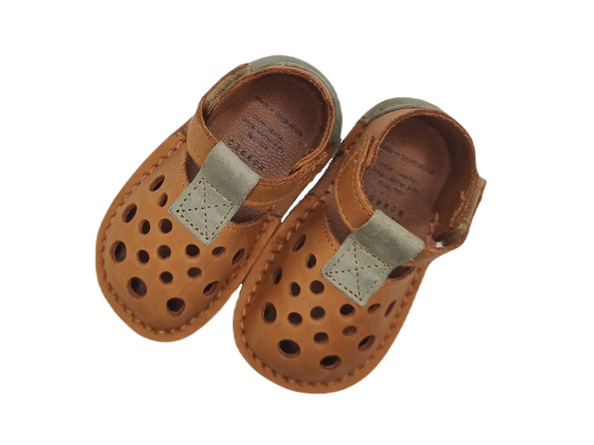 Brown leather toddler shoes with ventilation holes and green strap detail on white background