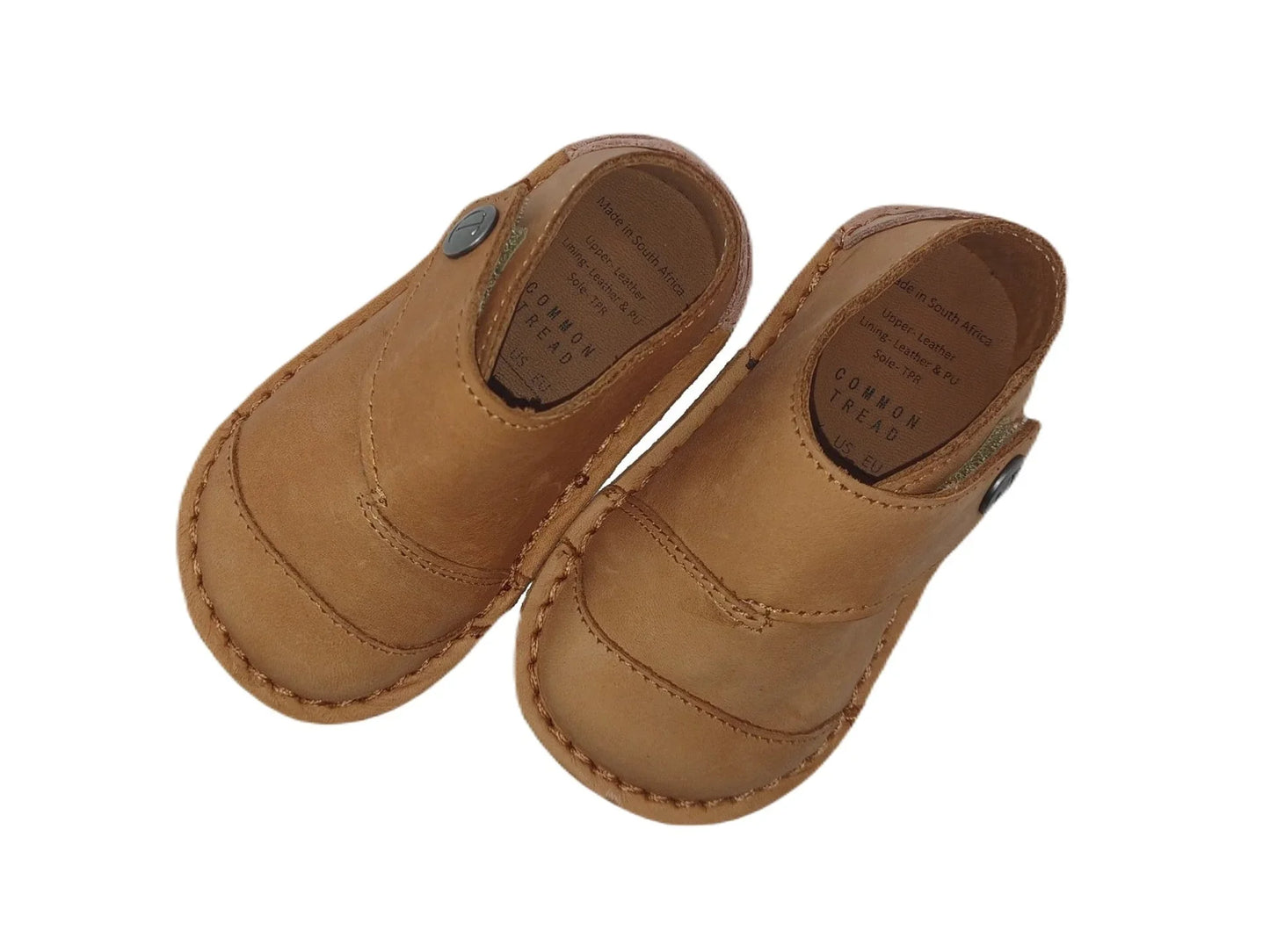 Pair of tan leather toddler shoes with button detail and stitched sole, made in South Africa