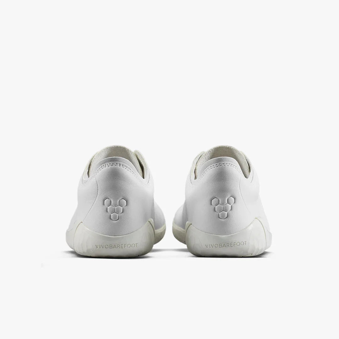 Rear view of white Vivobarefoot minimalist shoes with embossed logo on heels and clean white soles
