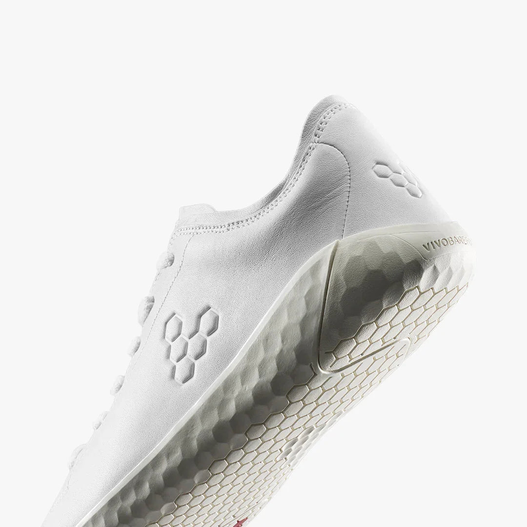 Close-up of white minimalist leather Vivobarefoot sneaker with honeycomb sole pattern