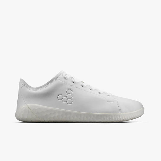 Side view of all-white minimalist sneaker with hexagonal embossed logo and textured sole