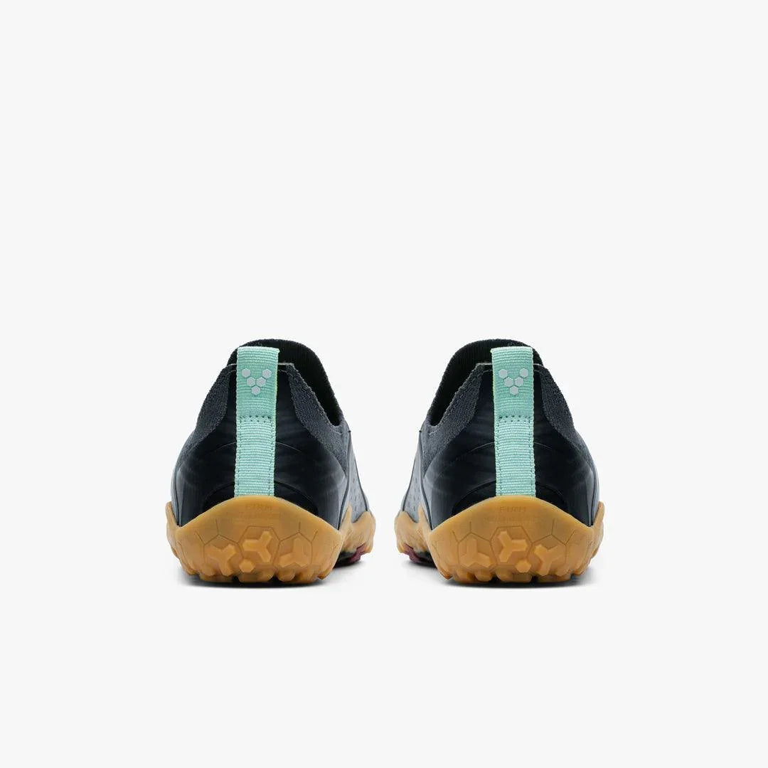Back view of black minimalist athletic shoes with gum soles and light blue heel tabs on white background