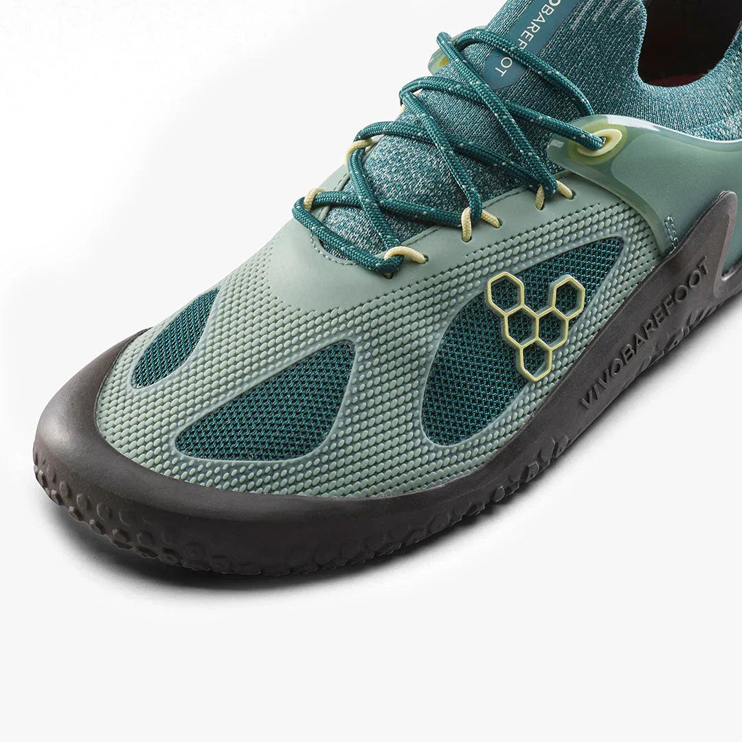 Close-up of modern teal Vivobarefoot barefoot shoe with textured upper and black sole