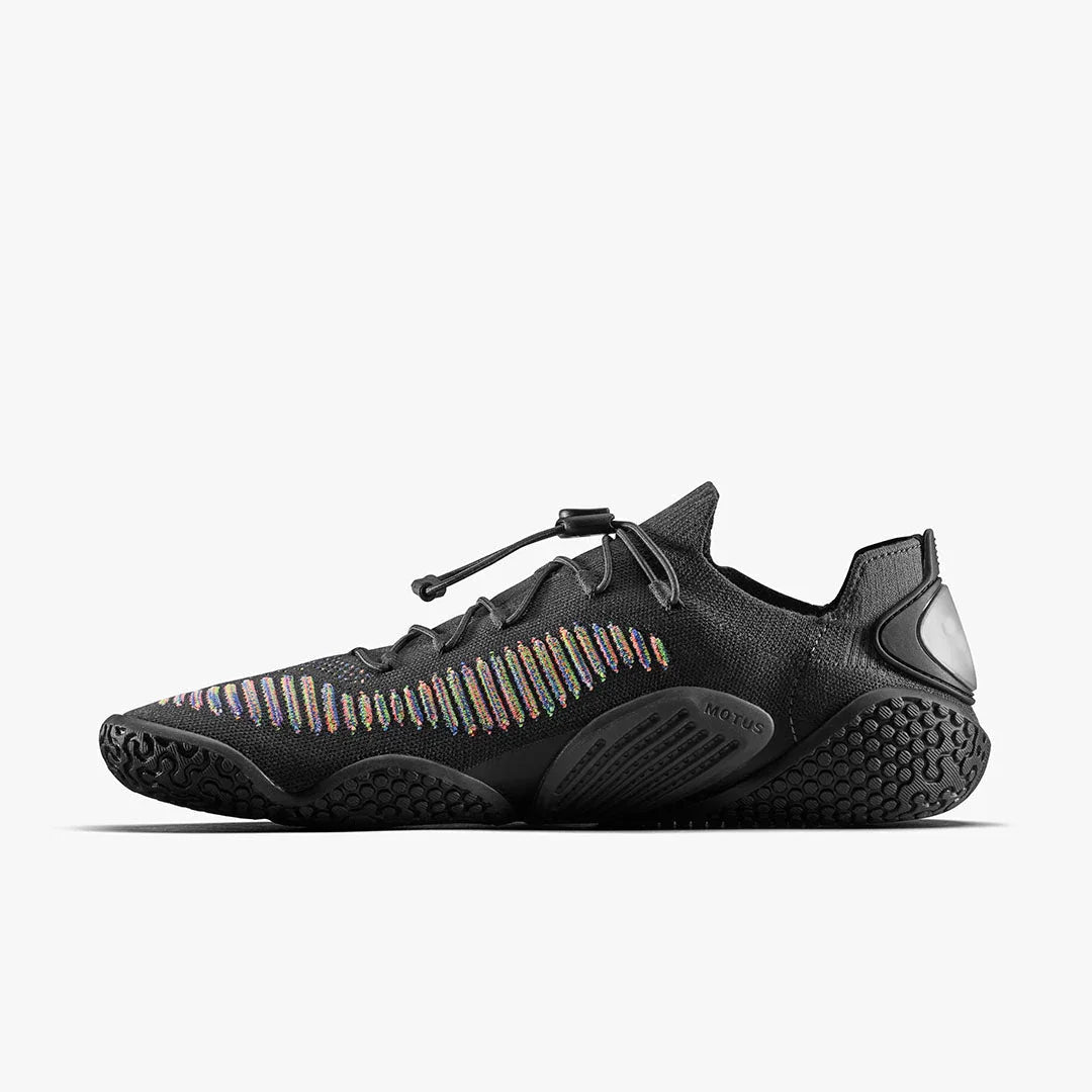 Black athletic shoe with rainbow knit detailing, textured sole, and slip-on design on white background