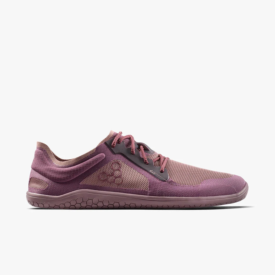 Lightweight purple minimalist running shoe with mesh upper and hexagonal sole pattern