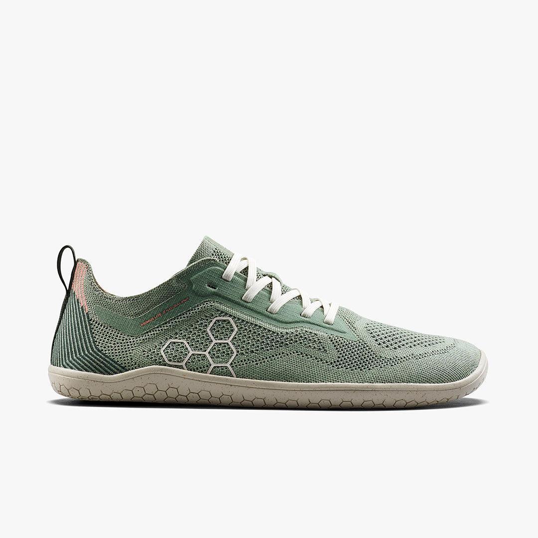 Minimalist green knit running shoe with white laces and honeycomb sole pattern