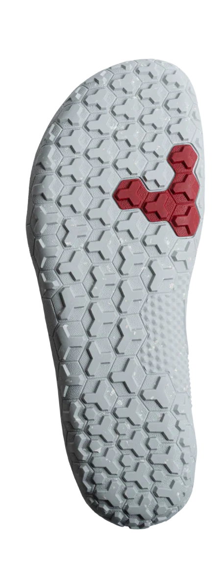 White shoe outsole with hexagonal tread pattern and a distinctive red triangular section