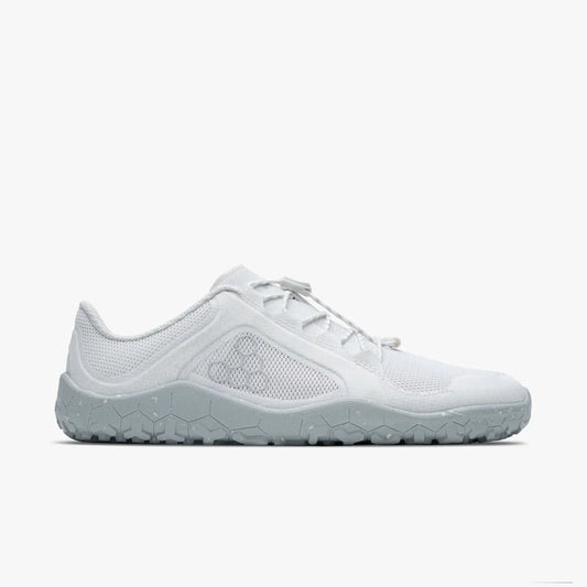 Minimalist white athletic shoe with textured sole and breathable mesh upper side view