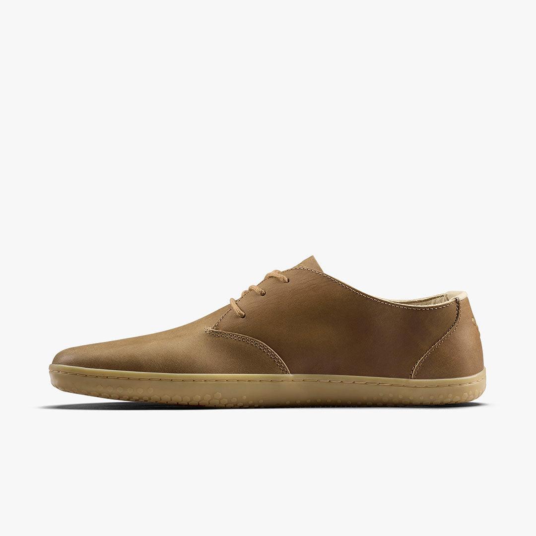 Minimalist brown leather casual shoe with beige sole and lace-up design on white background
