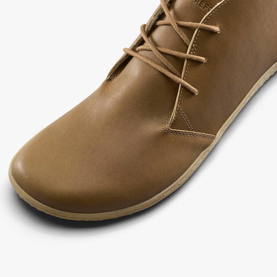 Close-up of tan leather casual shoe with matching laces and light beige sole