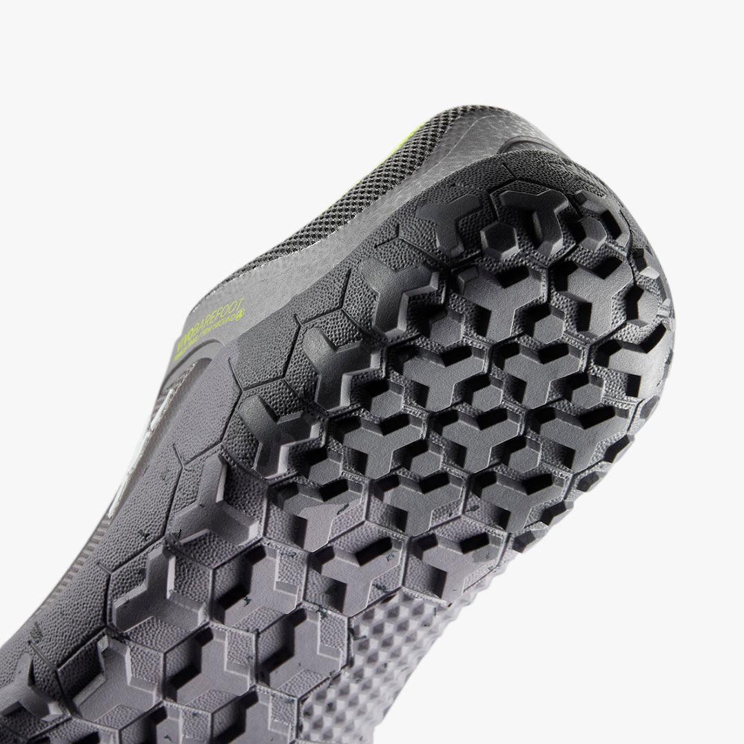 Close-up of black Vibram FiveFingers shoe sole with hexagonal tread pattern on white background