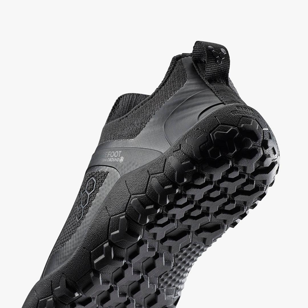 Closeup of black barefoot shoe with textured sole, sustainable eco-friendly footwear