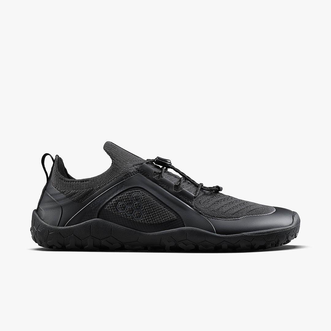 Black minimalist barefoot shoe with mesh and textured sole, eco-friendly design
