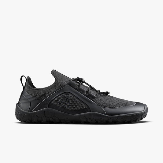 side view of black minimalist athletic shoe with textured sole and breathable mesh upper