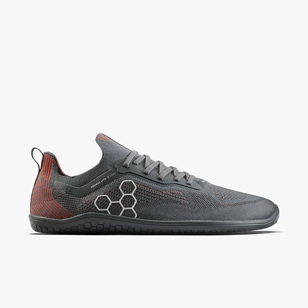 Gray and red knit lightweight athletic shoe with hexagonal side design and black rubber sole