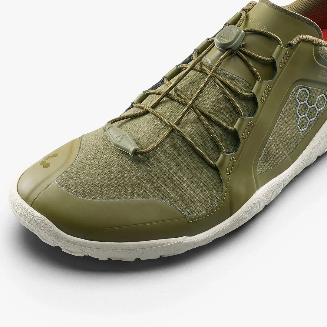 close-up of olive green lightweight athletic shoe with elastic laces and white sole