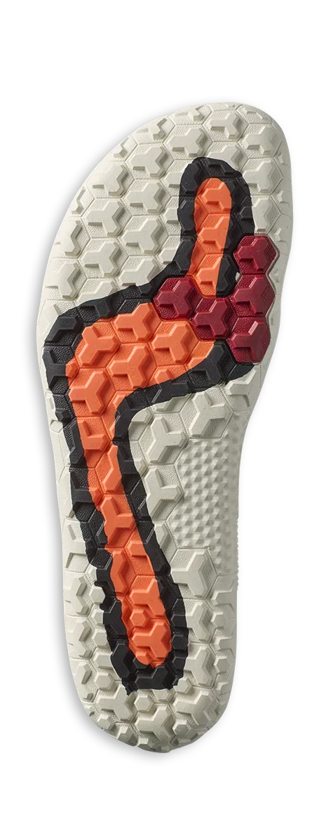White shoe outsole with hexagonal treads featuring orange, red, and black patterned grips