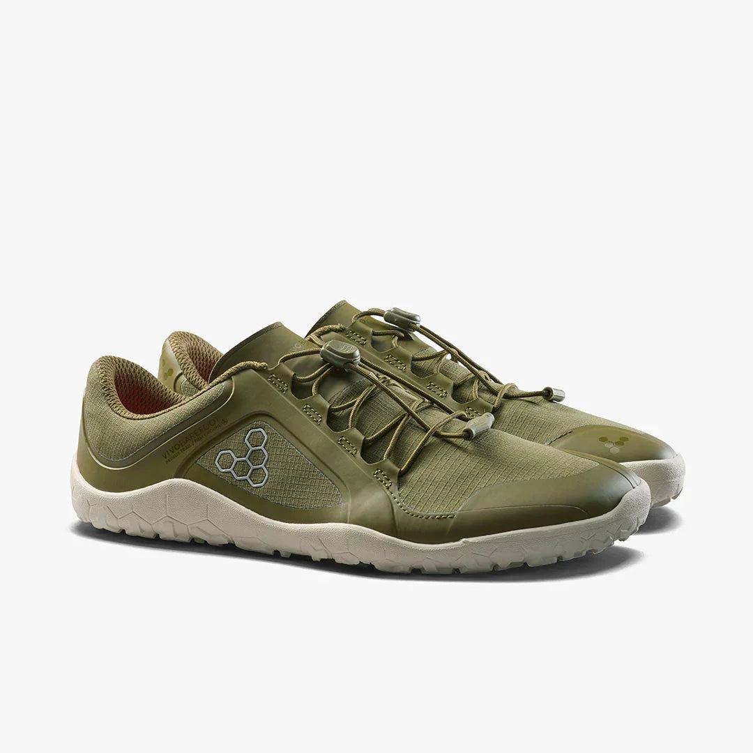 Pair of olive green minimalist running shoes with white textured soles and elastic laces