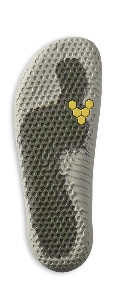 Gray shoe outsole with hexagonal textured grip pattern and three yellow hexagons near midfoot
