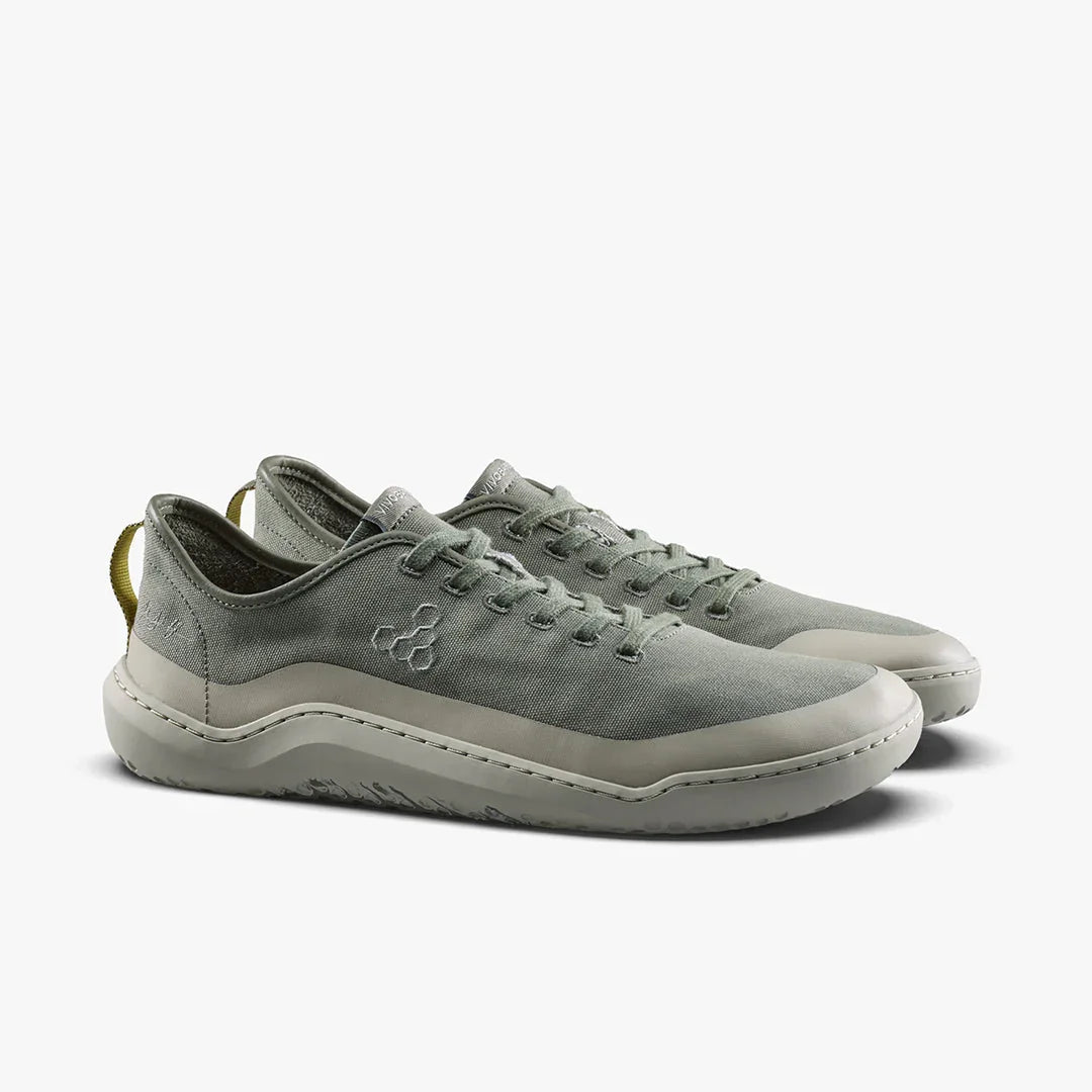 Light gray casual sneakers with fabric upper, lace-up design, and beige rubber sole on white background