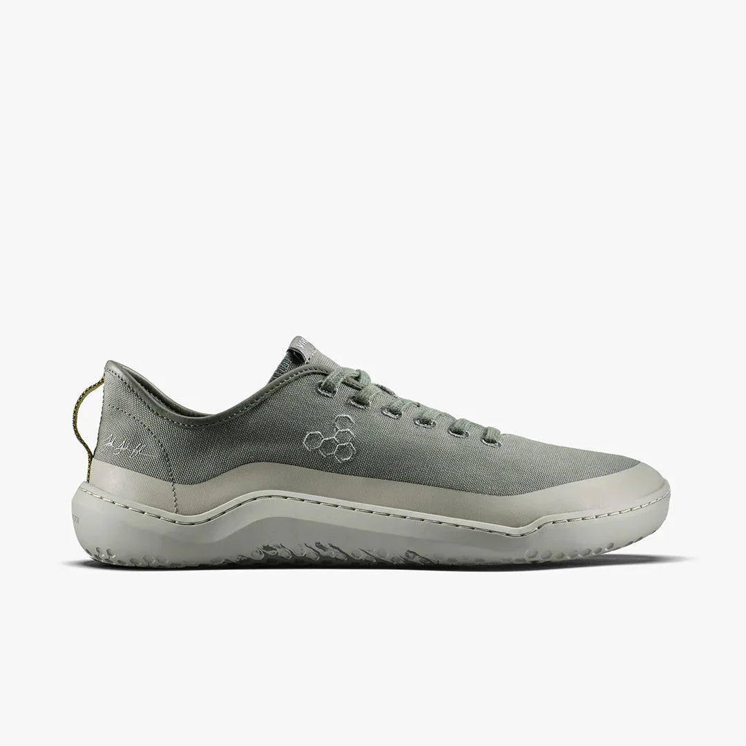 Side view of minimalist gray canvas sneaker with white sole and hexagon logo