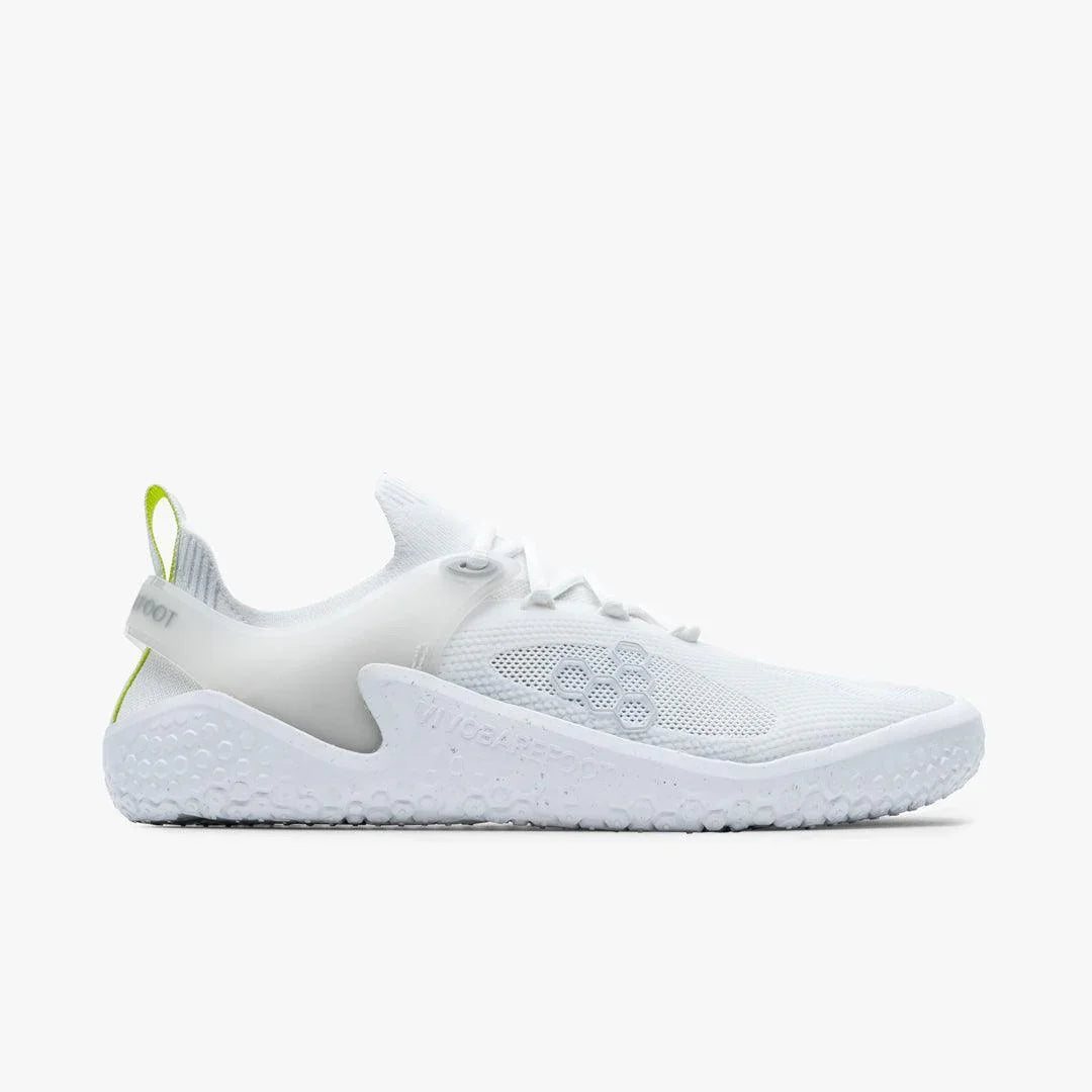 Side view of white minimalist athletic shoe with mesh upper and textured sole on white background
