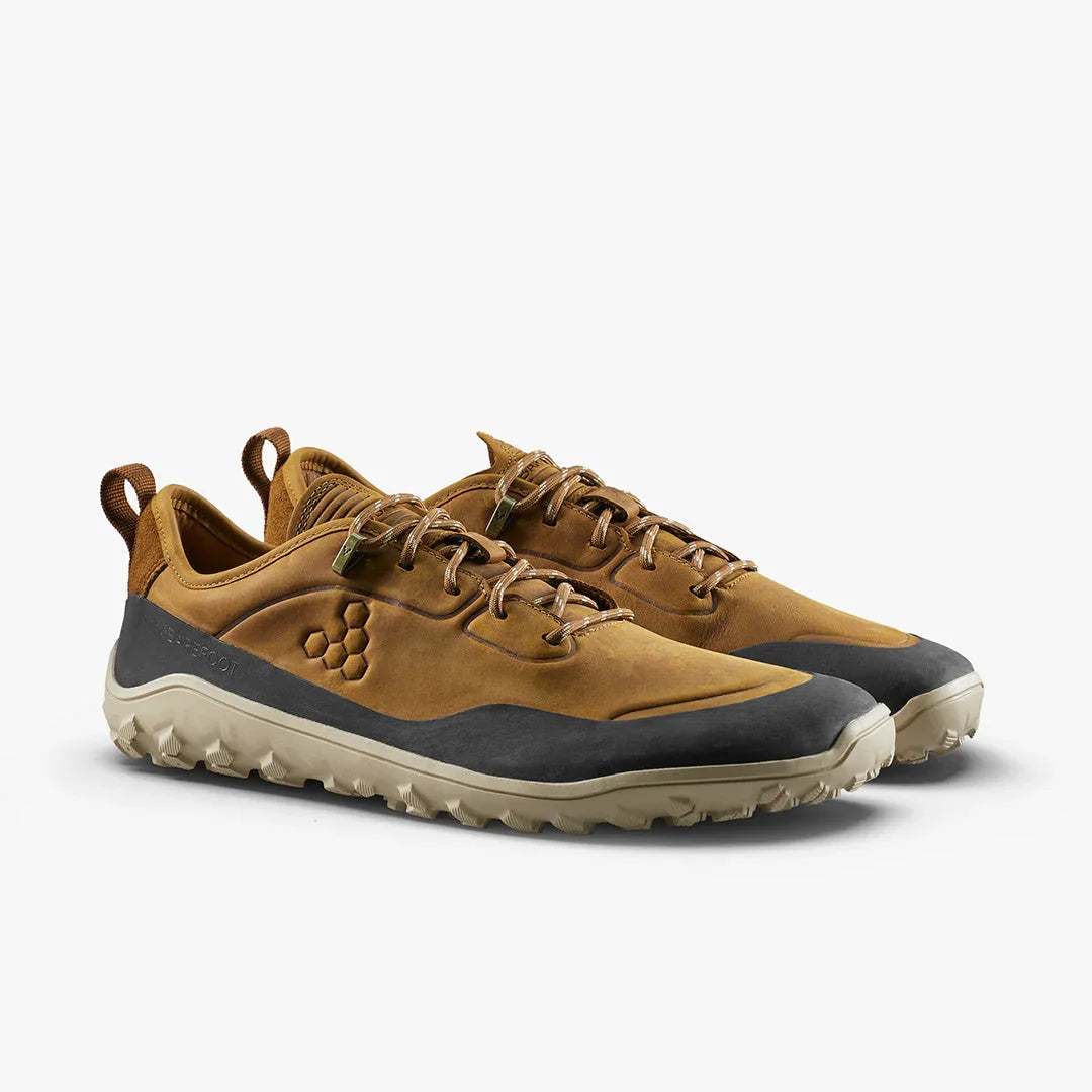 Pair of brown and black minimalist trail running shoes with rugged sole and loop pull tab