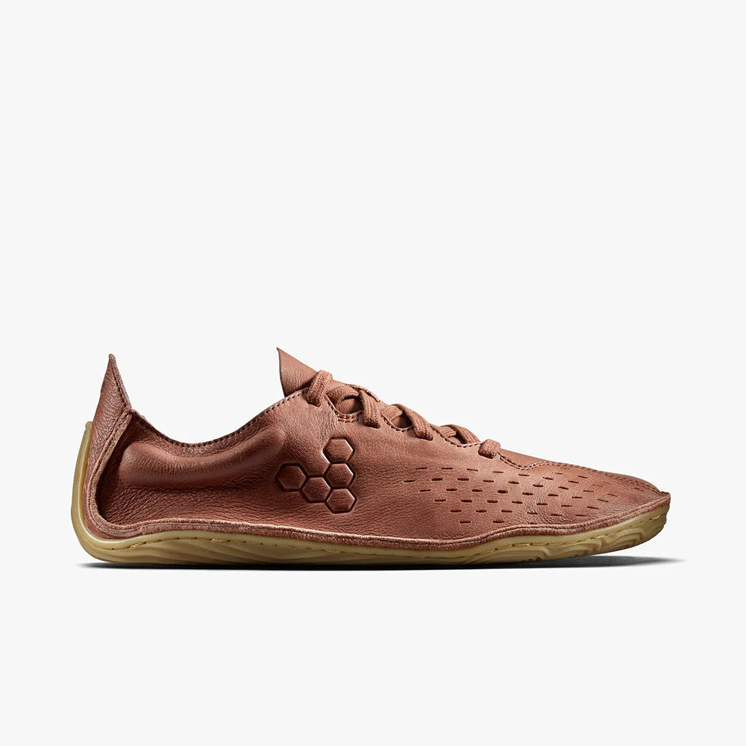 Side view of a brown minimalist barefoot shoe with hexagonal logo and flexible sole on white background