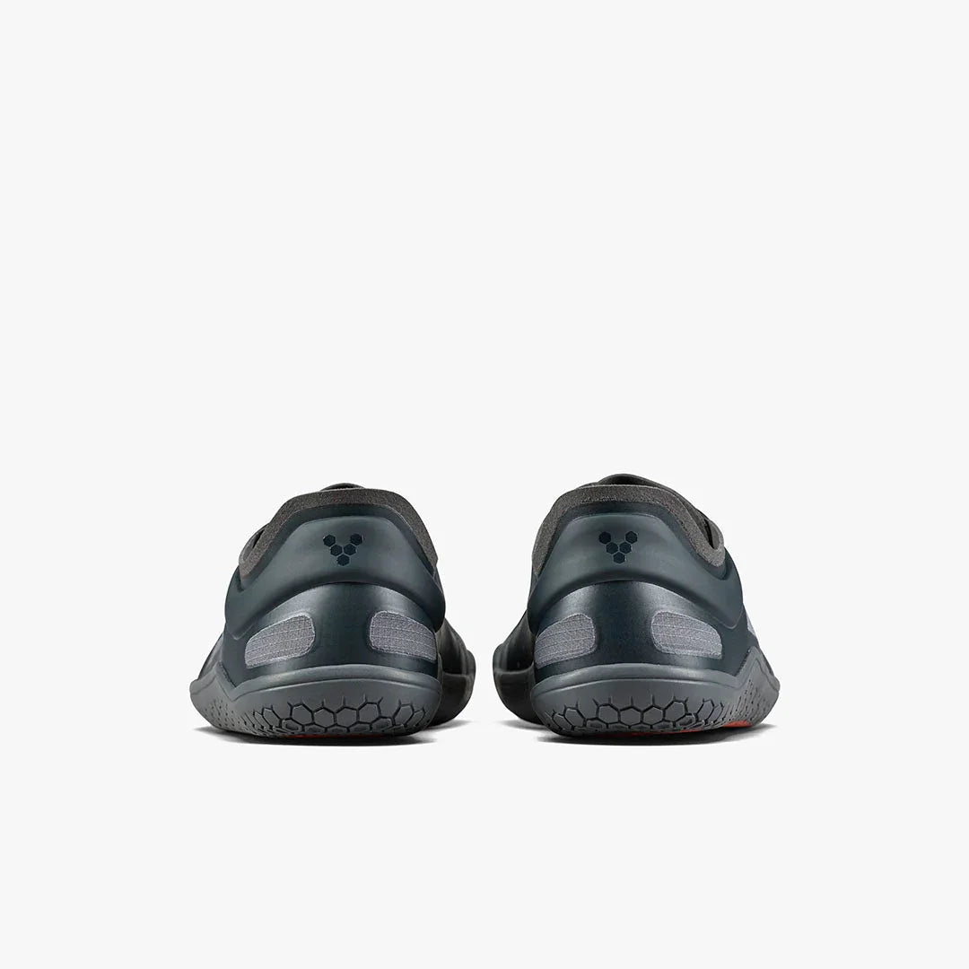 Back view of gray minimalist athletic shoes with hexagonal sole pattern on white background