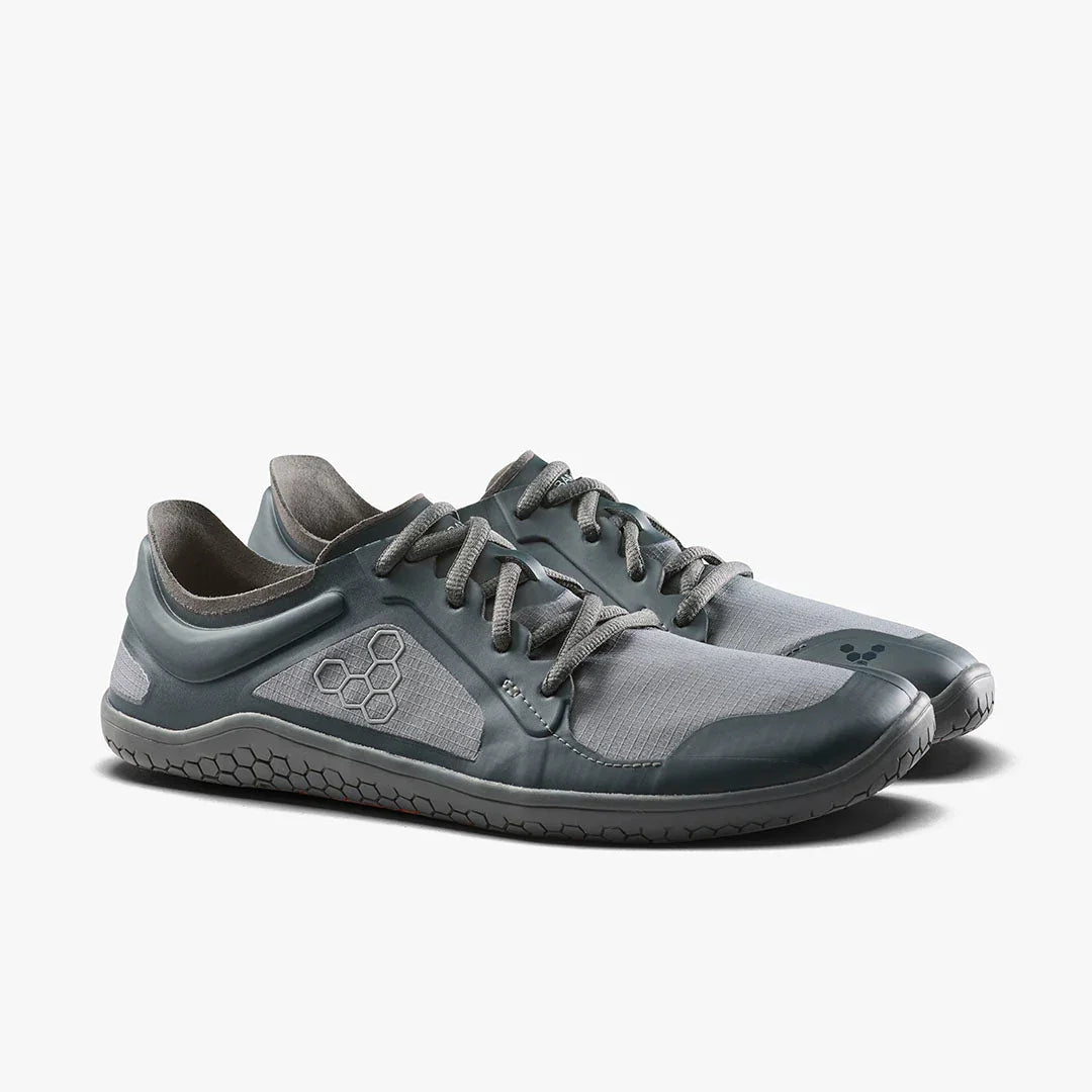 Pair of grey minimalist athletic lace-up shoes with hexagonal logo and flexible sole