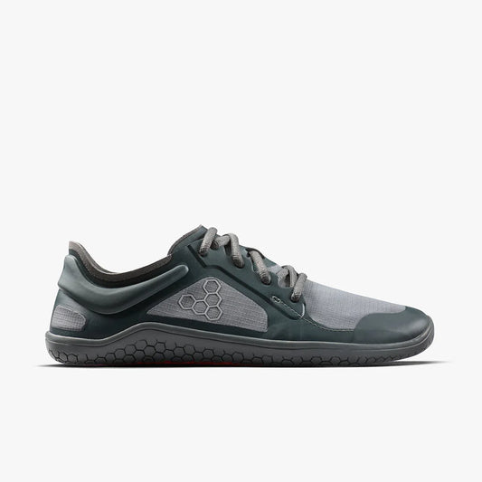 Side view of sleek gray and black minimalist athletic shoe with hexagonal sole pattern