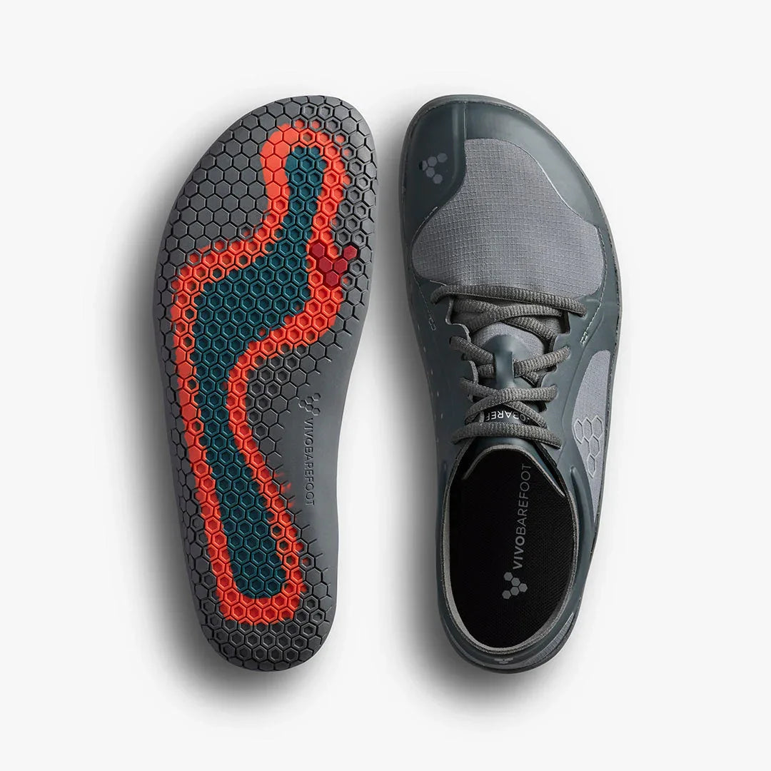 Gray Vivobarefoot minimalist shoe with honeycomb sole pattern and orange-blue footbed design