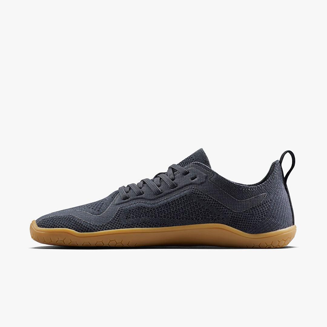 Minimalist black knit lightweight sneaker with gum rubber sole and pull tab
