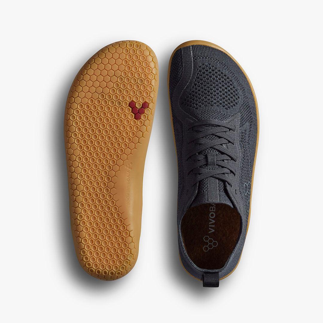 Vivobarefoot minimalist black knitted shoe with honeycomb-patterned gum sole, top and bottom view