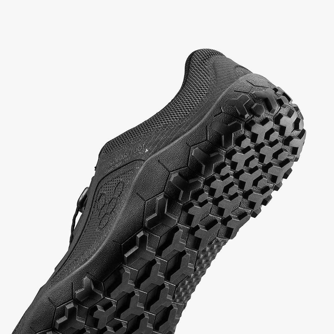 Close-up of black sustainable barefoot shoe with textured sole, eco-friendly footwear