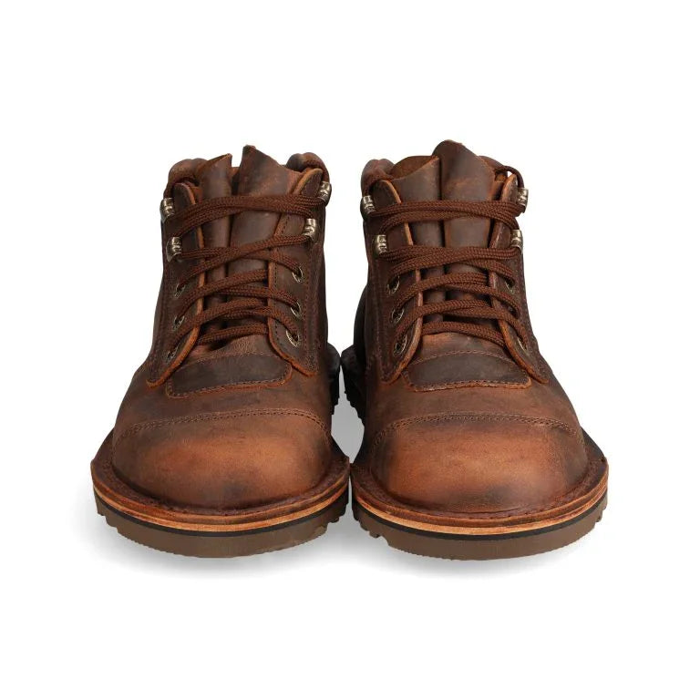Pair of brown leather boots on a white background