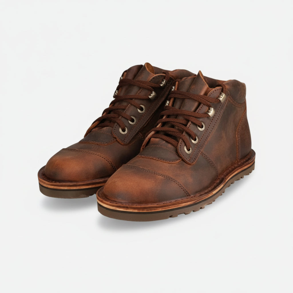 Pair of brown leather boots on a white background