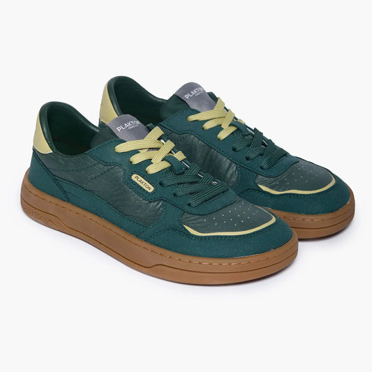 Green sneakers with brown soles on a white background